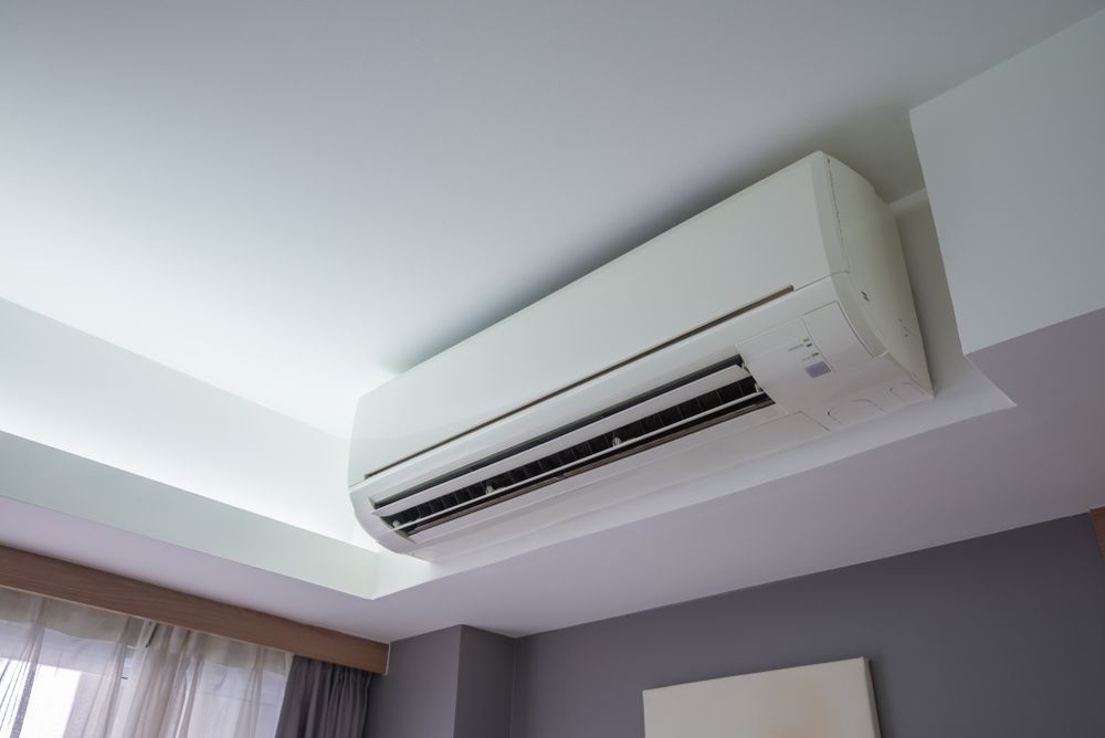 A White Air Conditioner is Hanging From the Ceiling in a Bedroom, Enterprise Air That's Cool in Svensson Heights, QLD