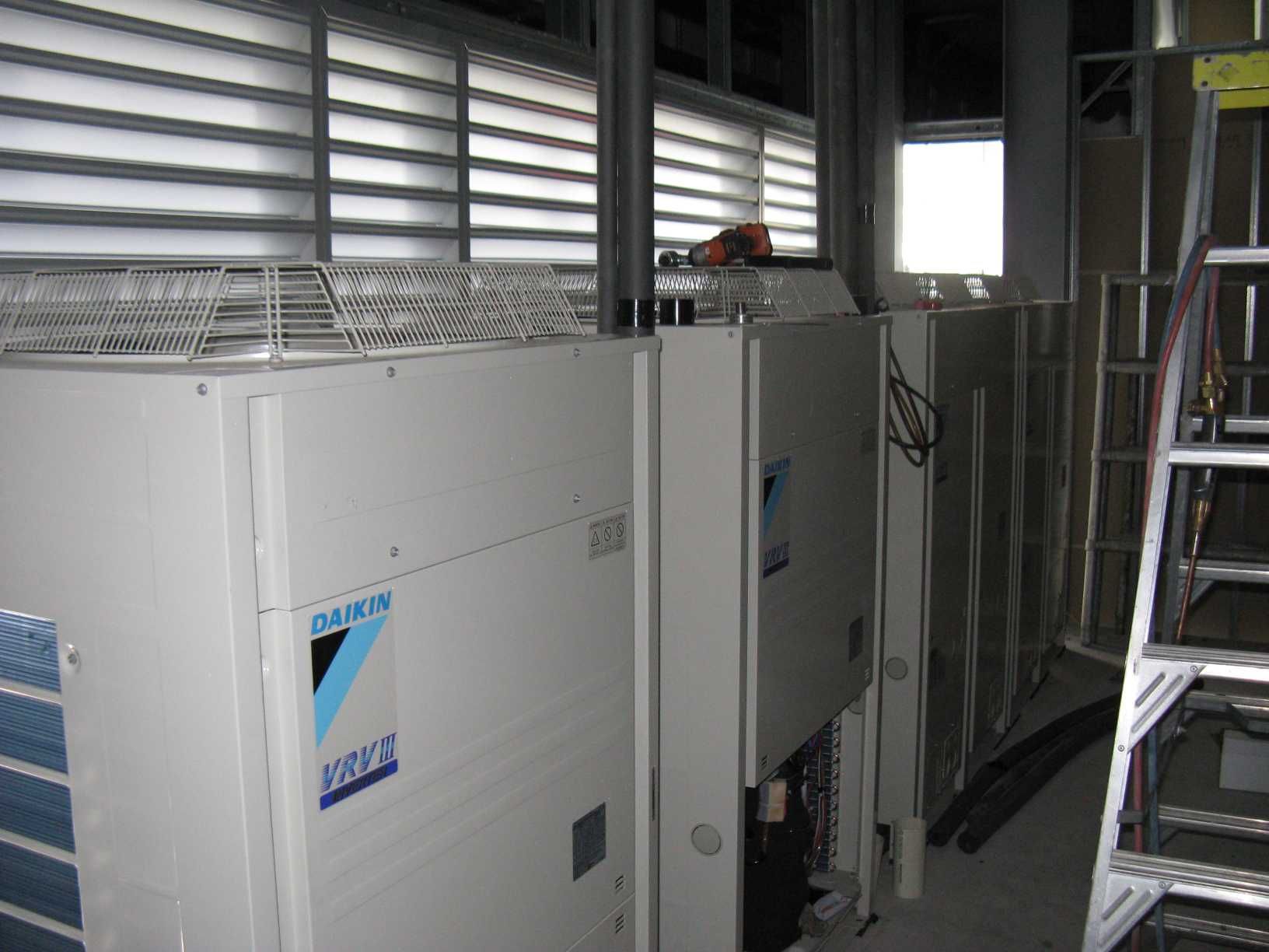 A Daikin Air Conditioner is Sitting in a Room Next to a Ladder, Enterprise Air That's Cool in Svensson Heights, QLD