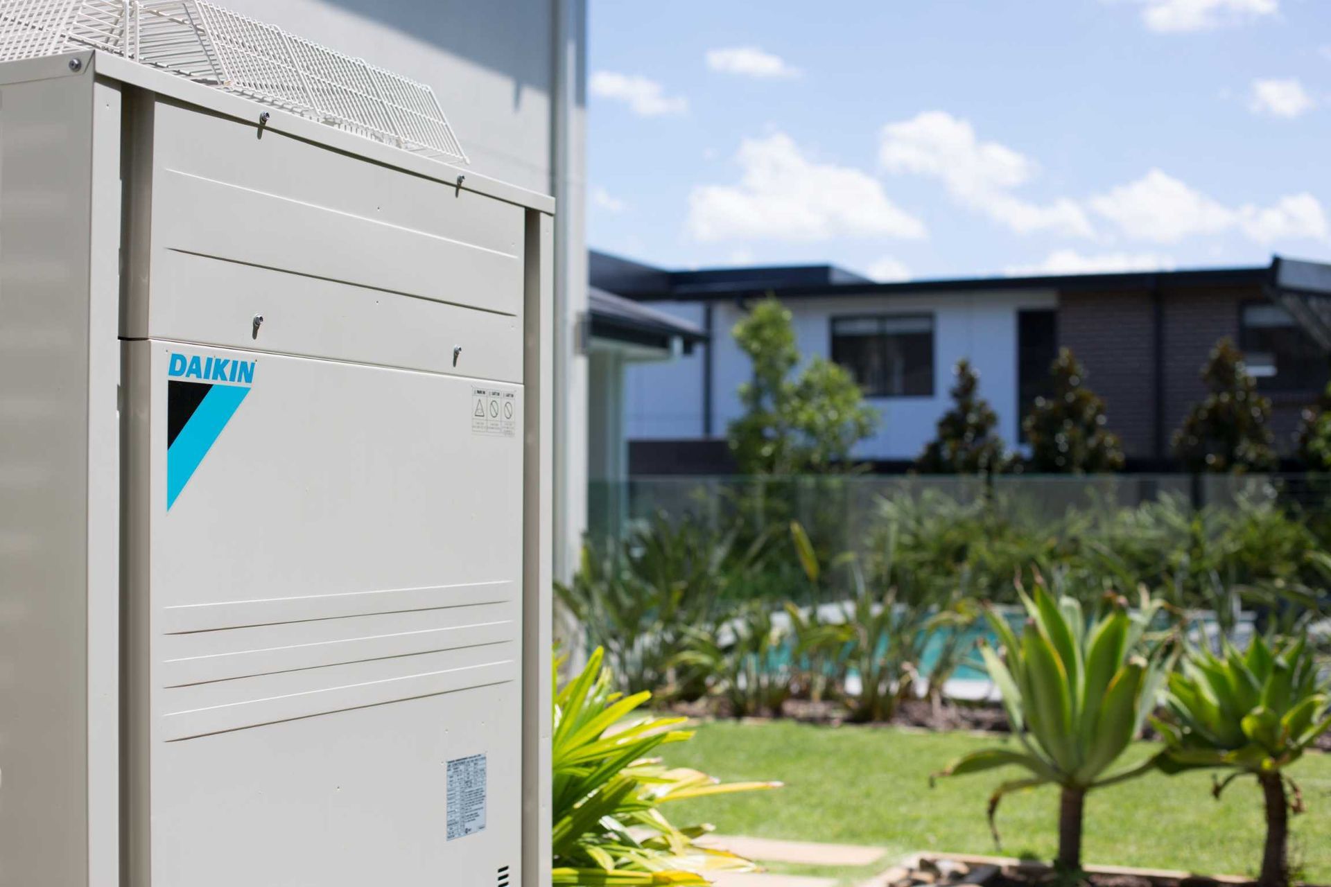 A Daikin Air Conditioner is Sitting Outside of a House, Enterprise Air That's Cool in Svensson Heights, QLD
