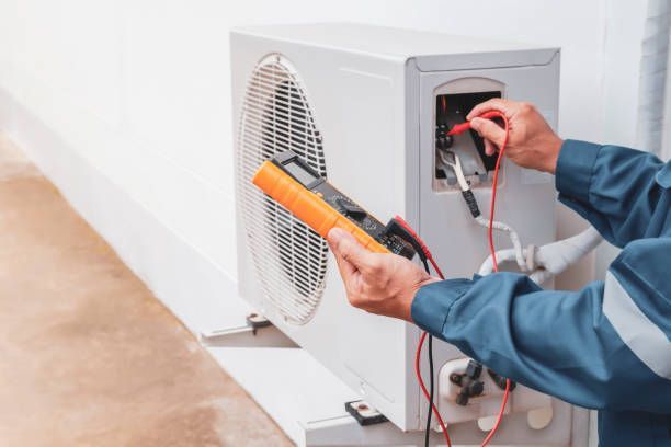 A Man is Fixing an Air Conditioner With a Multimeter, Enterprise Air That's Cool in South Bingera, QLD