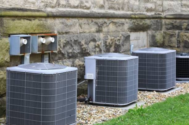 Air Conditioners Are Sitting Next to Each Other in Front of a Brick Wall, Enterprise Air That's Cool in Abbotsford, QLD