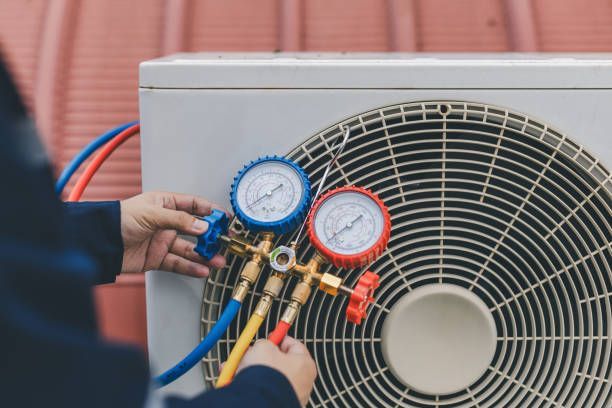 A Person is Working on an Air Conditioner With Two Gauges Attached to It, Enterprise Air That's Cool in Svensson Heights, QLD
