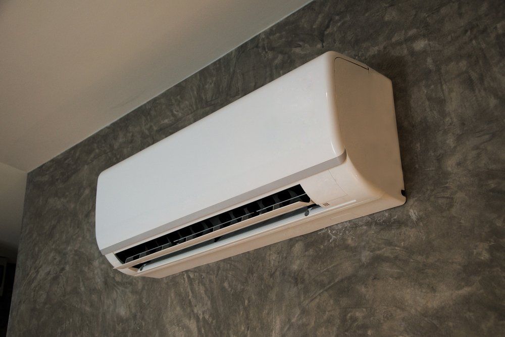 A White Air Conditioner is Hanging on a Concrete Wall, Enterprise Air That's Cool in Mon Repos, QLD